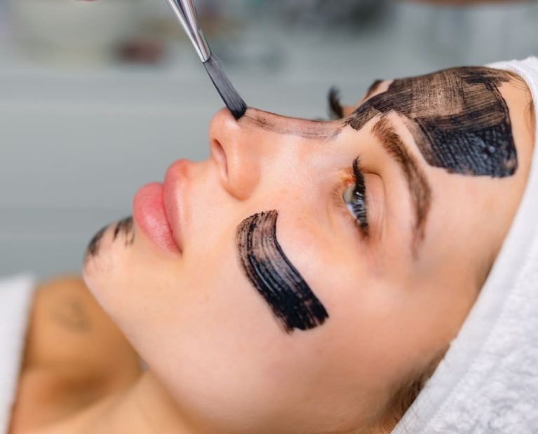 cosmetologist-applying-black-mask-on-pretty-woman-2025-03-08-06-14-51-utc (1)